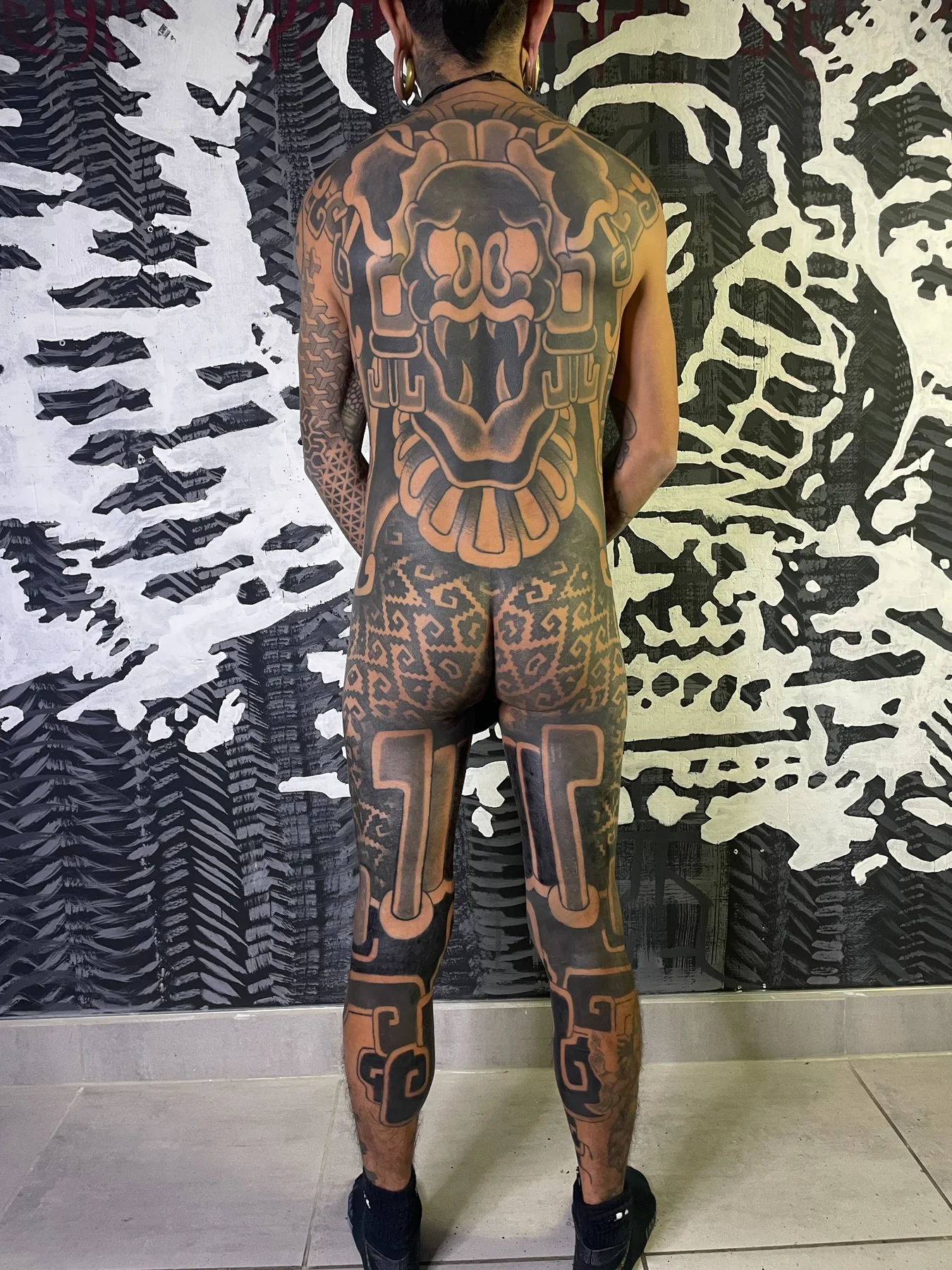 Large-scale ornamental full back tattoo