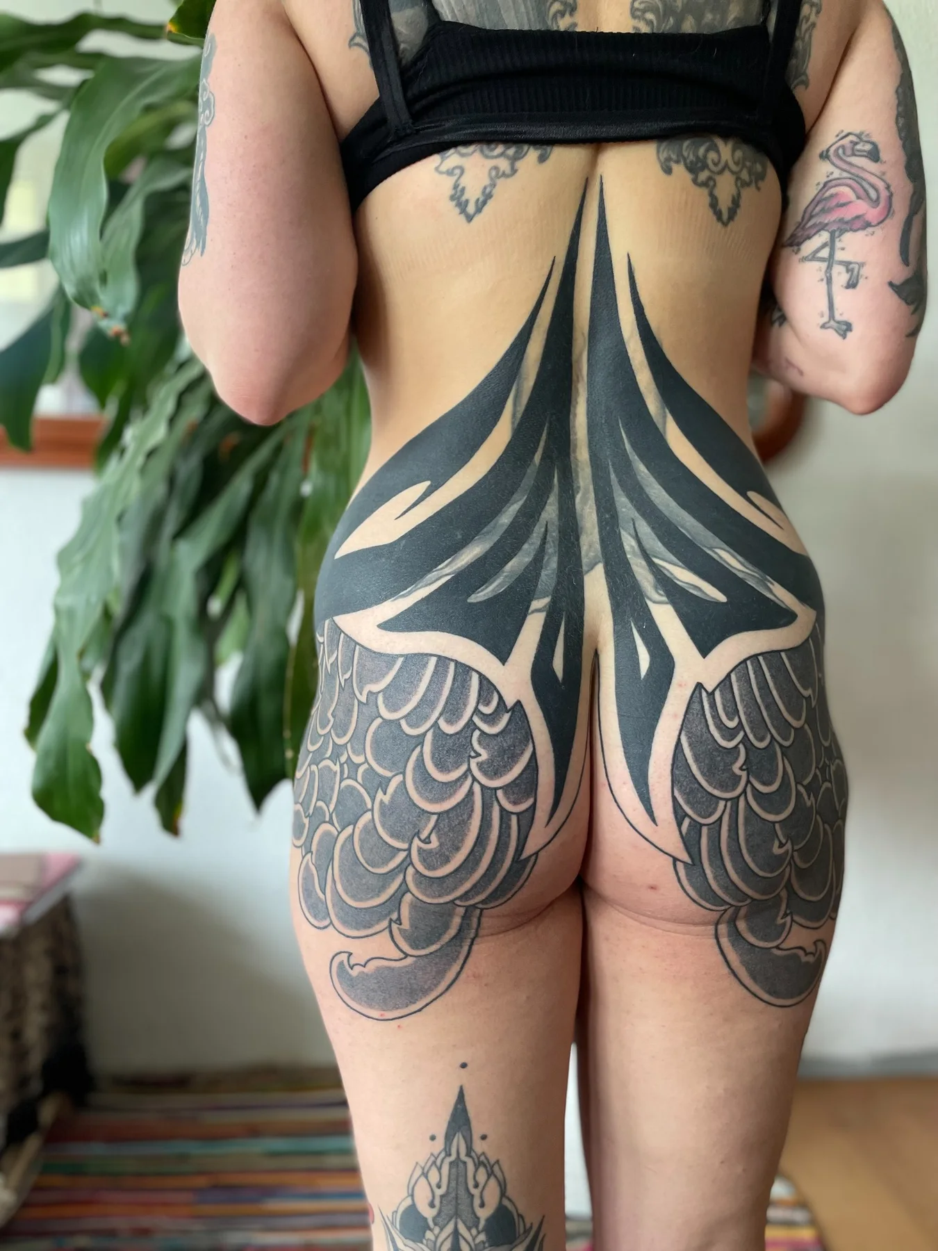 Blackwork composition across lower back and hips
